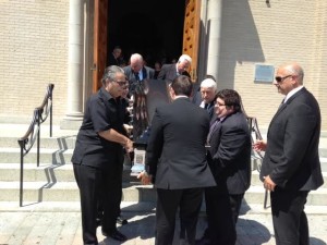 Pallbearers carry Joseph Del Grosso's casket out of St. Lucy's Church